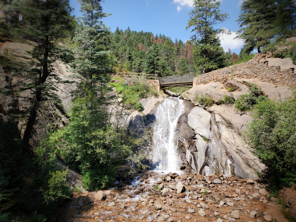 Colorado Road Trip Helen Hunt Waterfall, Bridge over falls with rocks and trees